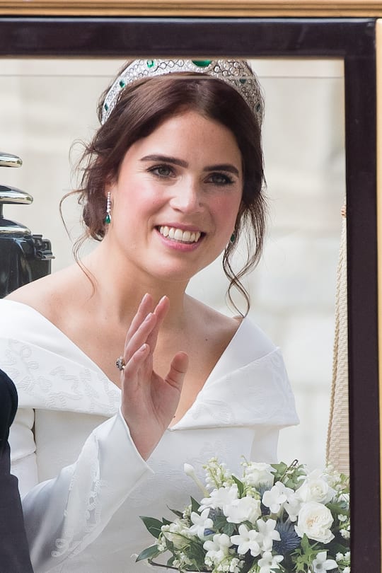 WINDSOR, ENGLAND - OCTOBER 12: Newlywed Princess Eugenie of York waves to the crowds from her carriage after her Royal wedding to Mr. Jack Brooksbank at St. George's Chapel on October 12, 2018 in Windsor, England. (Photo by Samir Hussein/WireImage)