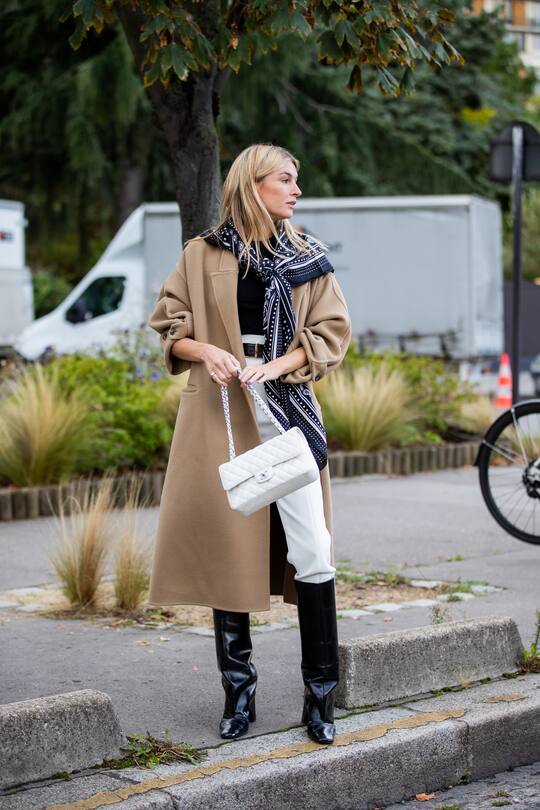 PARIS, FRANCE - OCTOBER 03: Camille Charriere wearing scarf, beige wool coat, white pants outside Hermes during Paris Fashion Week - Womenswear Spring Summer 2021 : Day Six on October 03, 2020 in Paris, France. (Photo by Christian Vierig/Getty Images)