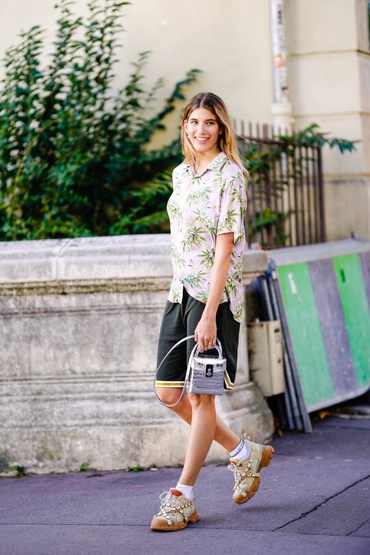 PARIS, FRANCE - SEPTEMBER 26: Veronia Heilbrunner wears floral print shirt, black shorts, a silver bag, during Paris Fashion Week Womenswear Spring/Summer 2019, on September 26, 2018 in Paris, France. (Photo by Edward Berthelot/Getty Images)