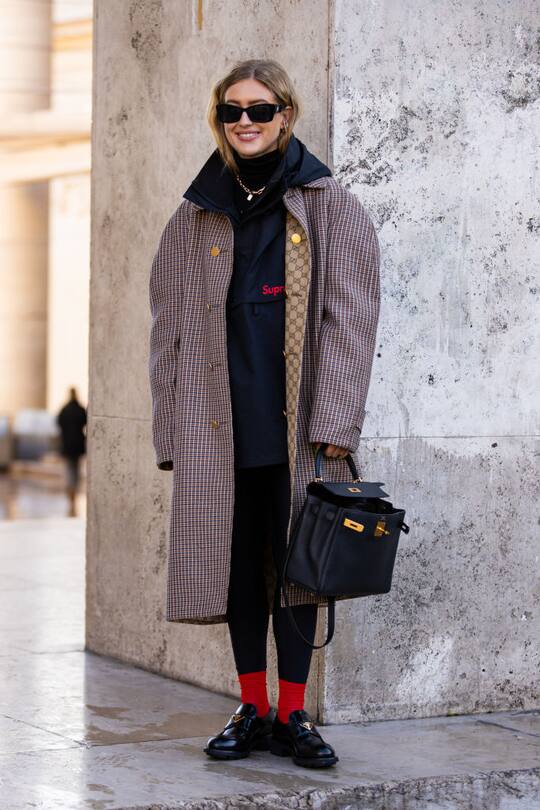 PARIS, FRANCE - FEBRUARY 29: Emili Sindlev, wearing a black Supreme jacket, Gucci coat, black bag, black leggins and black Prada loafers, is seen outside Rokh, during Paris Fashion Week - Womenswear Fall/Winter 2020/2021 : Day Six on February 29, 2020 in Paris, France. (Photo by Claudio Lavenia/Getty Images)