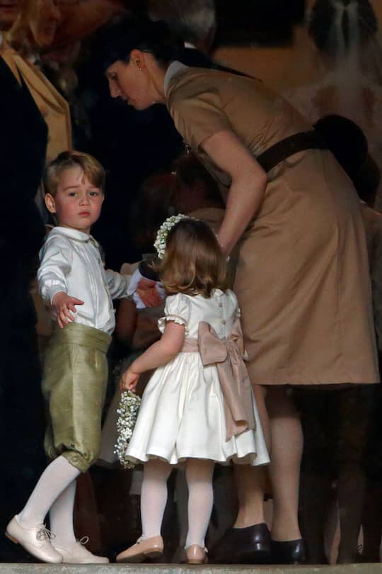 ENGLEFIELD GREEN, UNITED KINGDOM - MAY 20: (EMBARGOED FOR PUBLICATION IN UK NEWSPAPERS UNTIL 48 HOURS AFTER CREATE DATE AND TIME) Prince George of Cambridge and Princess Charlotte of Cambridge accompanied by their nanny Maria Teresa Borrallo attend the wedding of Pippa Middleton and James Matthews at St Mark's Church on May 20, 2017 in Englefield Green, England. (Photo by Max Mumby/Indigo/Getty Images)