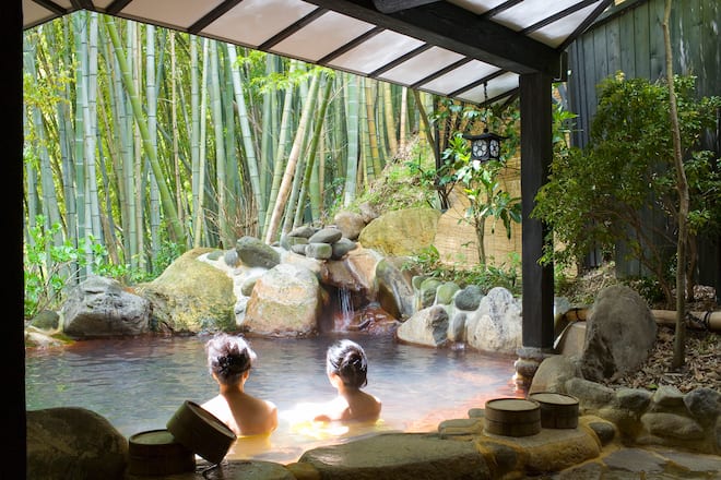 Women bathing in an outdoor pool (rotemburo) at Yumotoso - a hot spring resort in Kurokawa Onsen.