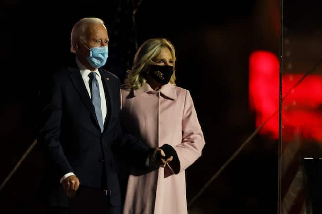 WILMINGTON, DELAWARE - NOVEMBER 04: Democratic presidential nominee Joe Biden and Dr. Jill Biden take the stage at a drive-in election night event at the Chase Center in the early morning hours of November 04, 2020 in Wilmington, Delaware. Biden spoke shortly after midnight with the presidential race against Donald Trump still too close to call. (Photo by Tasos Katopodis/Getty Images)