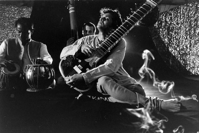 Musician Ravi Shankar passionately playing the sitar in a sitar meets jazz "jam sessionGÃÂ¥ while other musicians are backing him up in a room full of smoke. (Photo By Paul Schutzer/The LIFE Picture Collection via Getty Images)