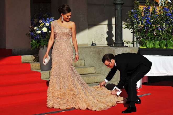 STOCKHOLM, SWEDEN - JUNE 18: Princess Victoria is helped with her dress by fiance Daniel Westling during the Government Pre-Wedding Dinner for Crown Princess Victoria of Sweden and Daniel Westling at The Eric Ericson Hall on June 18, 2010 in Stockholm, Sweden. (Photo by Pascal Le Segretain/Getty Images)