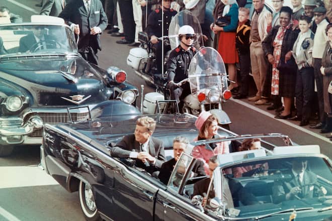 President and Mrs. John F. Kennedy smile at the crowds lining their motorcade route in Dallas, Texas, on November 22, 1963. Minutes later the President was assassinated as his car passed through Dealey Plaza.