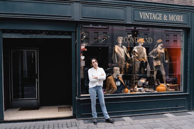 Full length of confident woman standing with arms crossed outside store model released Symbolfoto property released KNSF08009