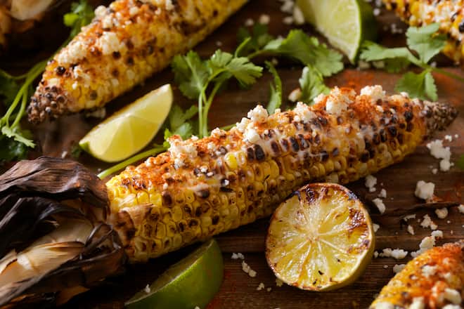 Mexican Style Street Corn with a Mayo, Sour Cream Sauce, Feta Cheese, Chili powder and Fresh Cilantro