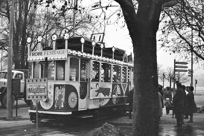 an old tram with christmas decoration in black and white